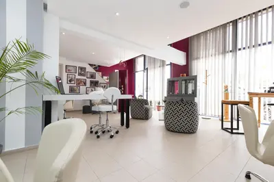 a living room with white chairs and a hair salon at Wazo Appart-Hôtel in Marrakech