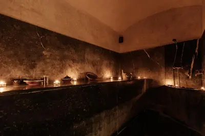 a dark room with a counter with candles on it at Wazo Appart-Hôtel in Marrakech