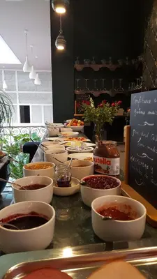 a buffet with bowls of food on a table at Riad Karmela Princesse in Marrakech