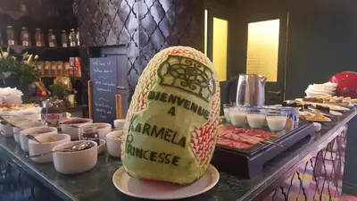 a large sandwich shaped like a burrito sitting on a buffet at Riad Karmela Princesse in Marrakech