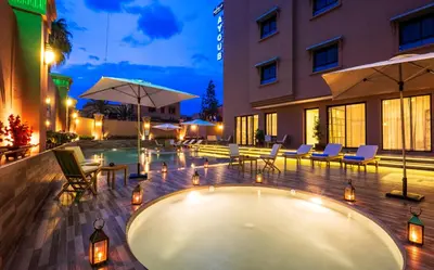 a pool in the middle of a building at Hotel Ayoub & Spa in Marrakech