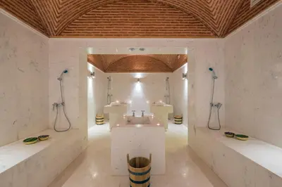 a bathroom with two showers and a sink in a room at Hotel Ayoub & Spa in Marrakech