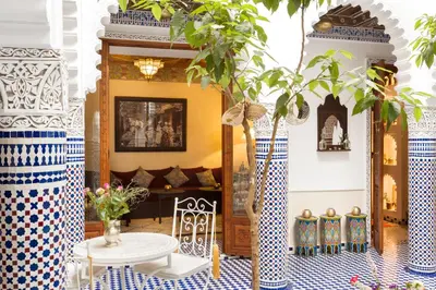 a living room with blue and white tiles and a table at Astra Damus Hotel in Marrakech