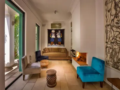 a living room with a couch and a fireplace at Riad Oasis 3 in Marrakech