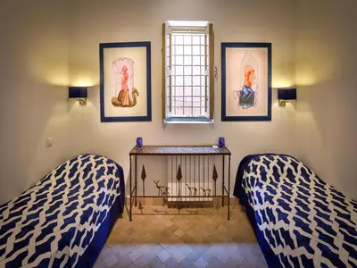 a room with two beds and a window at Riad Oasis 3 in Marrakech