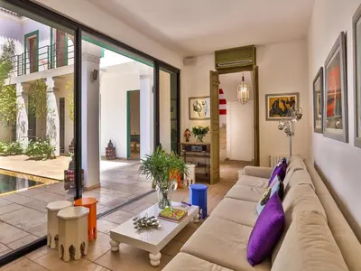 a living room with a couch and a table at Riad Oasis 3 in Marrakech