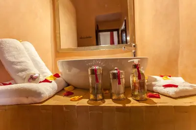 a bathroom with a sink and towels on a counter at Riad Dar Yema in Marrakech