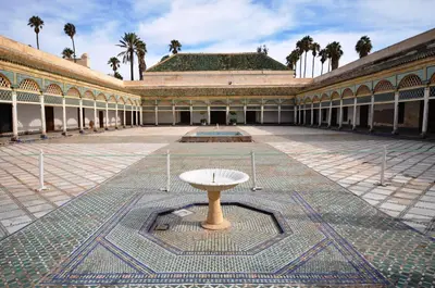 a building with a table in the middle of a courtyard at Riad Ayni in Marrakech