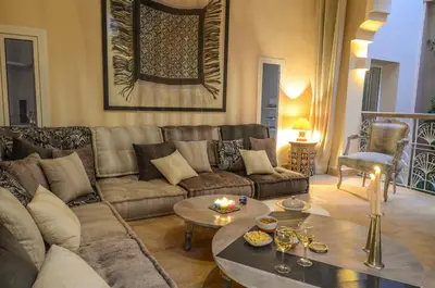 a living room with a couch and a table at Riad Ayni in Marrakech