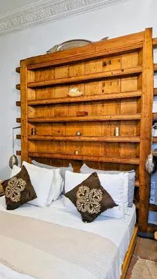 a bed with pillows on it in a room at Riad Laly Tourisme Eclairé Le bijou de la medina in Marrakech