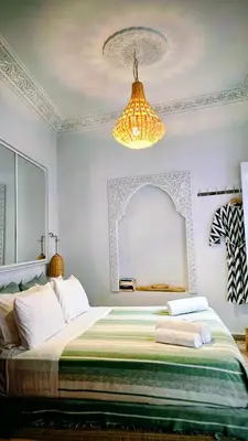 a bedroom with a large bed with a large mirror at Riad Laly Tourisme Eclairé Le bijou de la medina in Marrakech