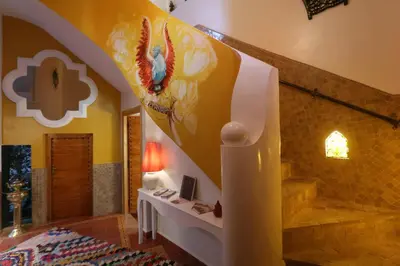a living room with a staircase and a room with a stair at Riad Andallaspa in Marrakech