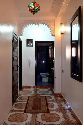 a hallway with a bathroom with a toilet and a door at Dar Yasser in Marrakech