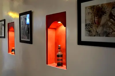a bottle of wine in a mirror on a wall at Dar Yasser in Marrakech