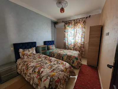 a bedroom with two beds and a window at Appartement Marrakech in Marrakech