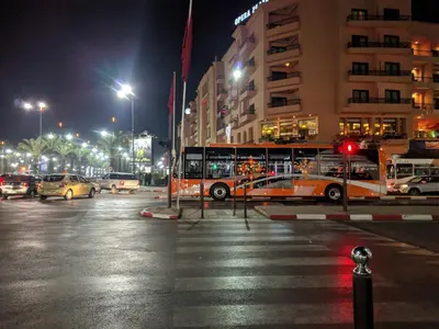 a bus on a city street at night at Appartement Marrakech in Marrakech