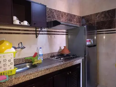 a kitchen with a stainless steel refrigerator and a sink at Appartement Marrakech in Marrakech