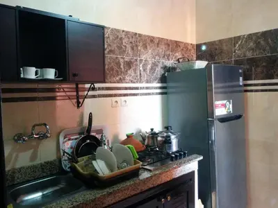 a kitchen with a sink and a refrigerator at Appartement Marrakech in Marrakech