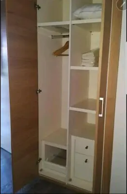 a closet with white shelves and a wooden door at Appartement Privé au Vizir Center Marrakech in Marrakech