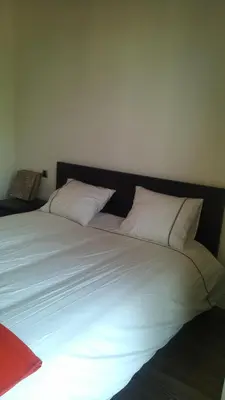 a large white bed with two pillows on it at Appartement Privé au Vizir Center Marrakech in Marrakech