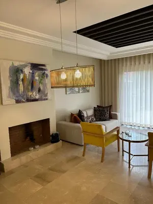 a living room with a couch and a fireplace at Appartement Privé au Vizir Center Marrakech in Marrakech