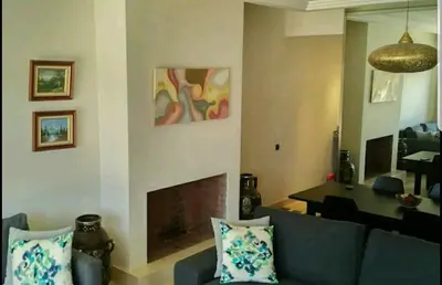 a living room with a couch and a fireplace at Appartement Privé au Vizir Center Marrakech in Marrakech
