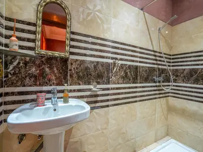 a bathroom with a sink and a shower at Riad Majdoulina chez JIJI in Marrakech
