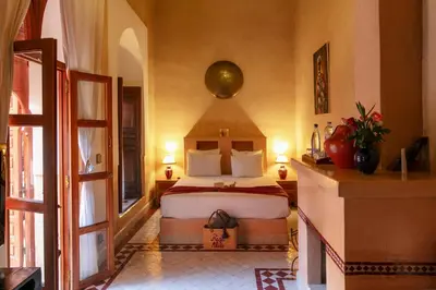 a bedroom with a large bed in a room at Riad Alili in Marrakech