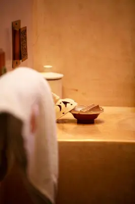 a nun standing on a counter with a bowl on it at Riad Alili in Marrakech