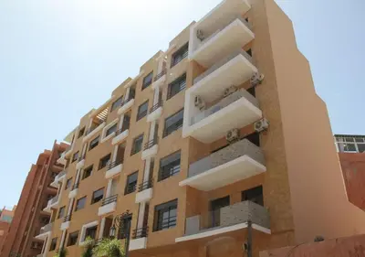 a building with balconies on the side of it at Appartement Nour Guéliz Marrakech in Marrakech