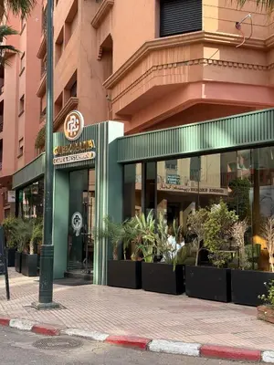 a store front of a building with plants at Appartement Nour Guéliz Marrakech in Marrakech