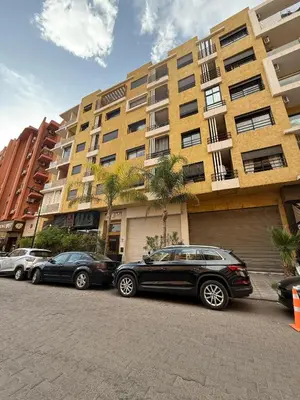 a row of cars parked in front of a building at Appartement Nour Guéliz Marrakech in Marrakech