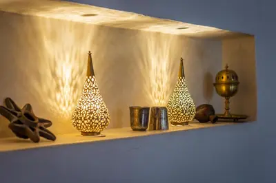 a shelf with three christmas tree vases on it at Riad Azahar in Marrakech