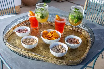 a tray with bowls of food and drinks on a table at Riad Azahar in Marrakech