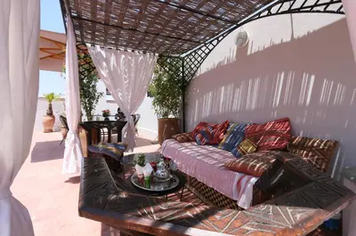 a living room with a couch and a table at Riad Merstane Marrakech in Marrakech