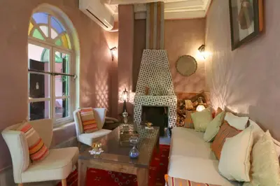 a living room with a couch and a fireplace at Riad Merstane Marrakech in Marrakech