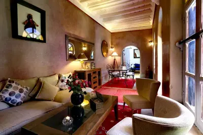 a living room with a couch and chairs and a table at Riad Merstane Marrakech in Marrakech