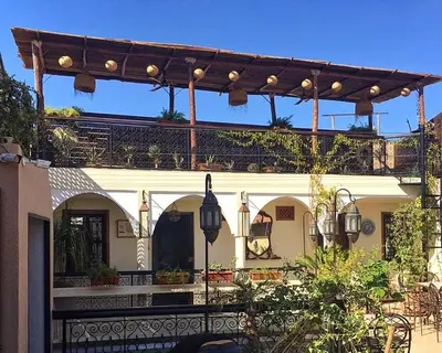a house with a pergola and a patio at Color Safrà in Marrakech