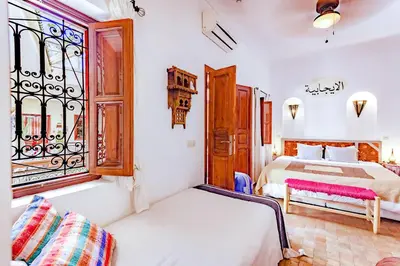 a bedroom with two beds and a window at Color Safrà in Marrakech