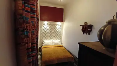 a small room with a small bed in the corner at Riad Tiziri in Marrakech