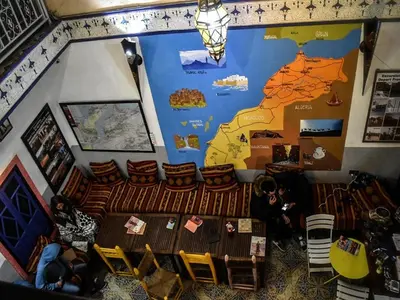 a room with a table and a map on the wall at Kasbah Red Castel Hostel in Marrakech