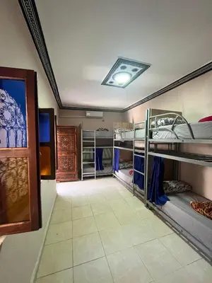 a room with several bunk beds in it at Kasbah Red Castel Hostel in Marrakech