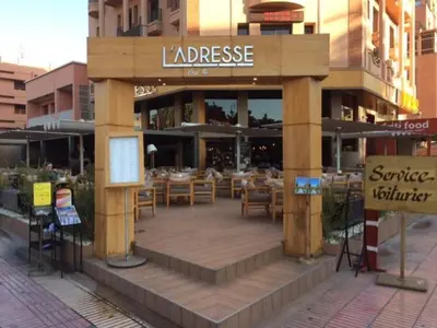 a restaurant with tables and chairs in front of a building at Appartement Wassim - Gueliz in Marrakech