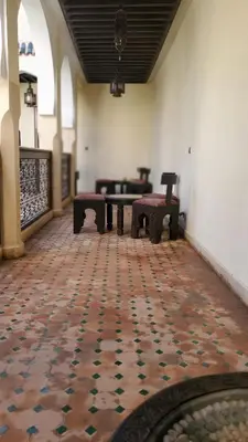 a room with benches and a table in a building at Riad Tidar by Phoenix in Marrakech
