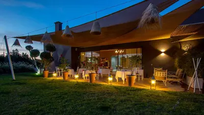 a patio with a table and lights on the grass at Villa Jardins D'Isa in Marrakech
