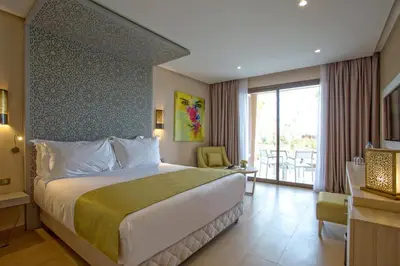 a hotel room with a bed and a balcony at Be Live Collection Marrakech Adults Only All inclusive in Marrakech