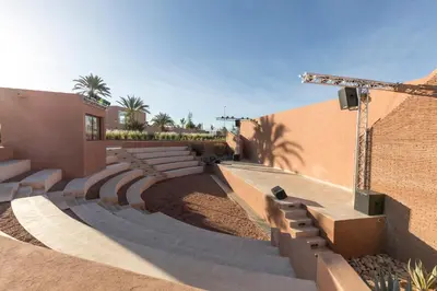 a building with steps and a wall with palm trees at Be Live Experience Marrakech Palmeraie - All Inclusive in Marrakech