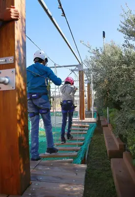 two people on a zip line in a park at Kenzi Club Agdal Medina - All Inclusive in Marrakech