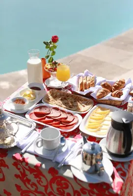 a table topped with plates of food and desserts at Kenzi Club Agdal Medina - All Inclusive in Marrakech