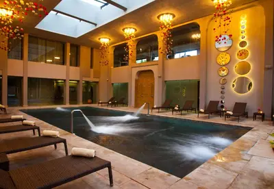 a large building with a swimming pool in a building at Kenzi Club Agdal Medina - All Inclusive in Marrakech
